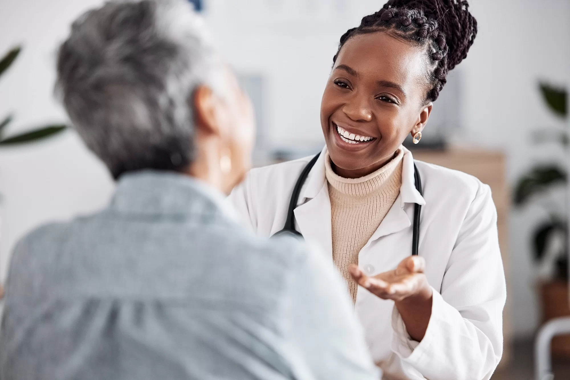 A smiling doctor talks to her patient.
