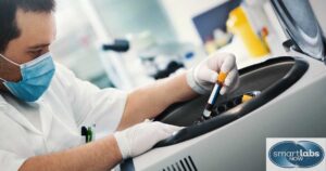 A lab tech centrifuging a blood sample.