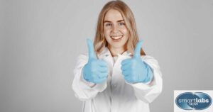 A lab technician giving the thumbs up sign.