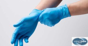 A lab tech wearing gloves to conduct a physical STD exam