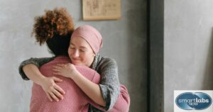 A cancer patient being comforted/hugged by a nurse