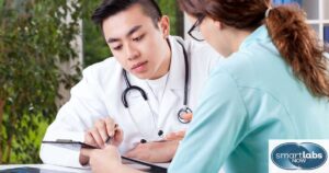 A doctor explaining a patient's Chlamydia test results to a staff nurse.