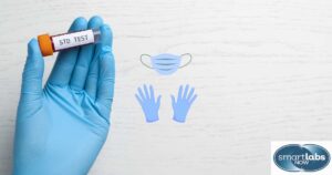 Graphic representation of a lab technician's gloved hand holding an STD blood test sample.