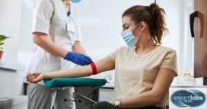 A lab technician drawing blood from a patient for Herpes testing