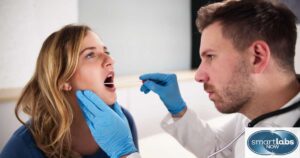 A lab technician taking a woman's cheek swab sample for DNA testing.