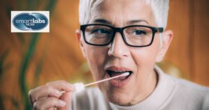 A woman taking a saliva swab sample at home.