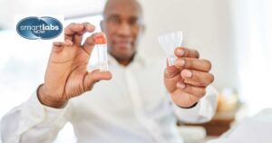 A man holding his saliva sample in a sealed tube.